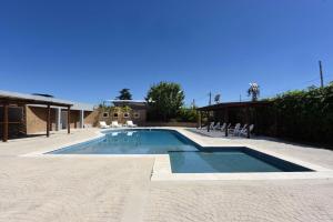 a large swimming pool with chairs at Camberland Resort & Spa Ramallo in Ramallo