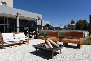 a group of benches sitting in front of a building at Camberland Resort & Spa Ramallo in Ramallo