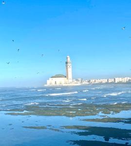 a lighthouse in the middle of a body of water at appartement en plein centre de casablanca in Casablanca