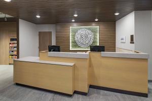 an office with two reception desks and a painting on the wall at Fairfield Inn and Suites by Marriott St Louis Downtown in Saint Louis