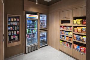 a walk in pantry with an open refrigerator at Fairfield Inn and Suites by Marriott St Louis Downtown in Saint Louis