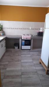 a kitchen with a counter with a stove in it at Victoria apart in San Ramón de la Nueva Orán