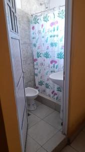 a bathroom with a shower curtain and a sink at Victoria apart in San Ramón de la Nueva Orán