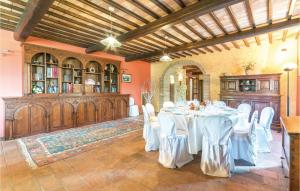 a dining room with white tables and white chairs at Holiday home Torgiano PG with a Fireplace 234 in Brufa