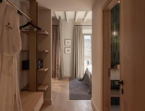 a room with a hallway with a bed and a room with a hallway at Can Verí Suites in Sóller