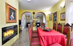 a dining room with a table and a fireplace at Pet Friendly Home In Sv,kriz Zacretje With Jacuzzi in Gornja Pačetina