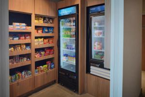 a kitchen with two refrigerators with food inside of it at Fairfield Inn & Suites by Marriott Stony Creek in Stony Creek