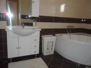 a bathroom with a sink and a bath tub at Apartman Toni in Bibinje +15 photos