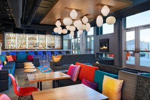 a restaurant with colorful furniture and tables at Aloft Waco Downtown in Waco