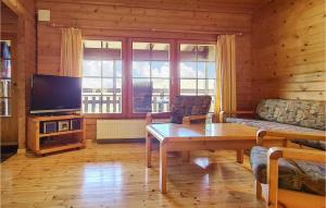 a living room with a couch and a table and a tv at Beautiful Home In Masserberg Ot Fehrenba With Wifi And 2 Bedrooms in Fehrenbach