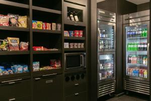 a kitchen with a refrigerator with food and drinks at Courtyard Elkhart in Elkhart