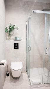 a bathroom with a toilet and a glass shower at NeroHome Bed&Breakfast in Łomża