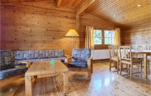 a living room with a couch and a table and chairs at Amazing Home In Masserberg Ot Fehrenba With House A Panoramic View in Fehrenbach