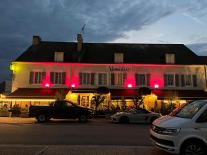 a large white building with red lights on it at Absolue Renaissance in Magny-Cours