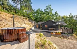 a house on a hill with a wooden deck at Beautiful Home In Ebeltoft With Kitchen in Ebeltoft