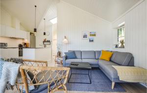 a living room with a couch and a table at Beautiful Home In Ebeltoft With Kitchen in Ebeltoft