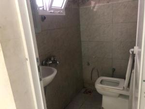 a small bathroom with a toilet and a sink at Haret Nizwa hostel in Nizwa