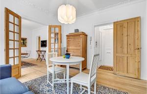 a living room with a white table and chairs at Amazing Apartment In Aarhus C With 1 Bedrooms And Wifi in Aarhus