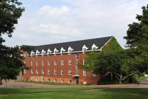 a large red brick building with a black roof at Dalhousie University Agricultural Campus in Truro