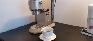 a coffee maker and a cup of coffee on a counter at Studio apartman Ada in Samobor