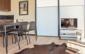 a living room with a dining table and a television at Gorgeous Ship In Nieuwpoort With House Sea View in Nieuwpoort