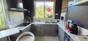 a small kitchen with a sink and a toilet at Maison lumineuse dans un cadre verdoyant in Saint-Prix