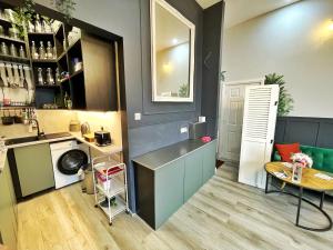 a kitchen with a counter and a table in a room at AdeamStays provides Beautiful centrally located 1 and 2 bed apartments on Liverpools Boulevard in Liverpool