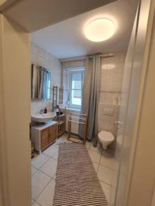 a bathroom with a sink and a toilet and a sink at Geräumige Wohnungen Zentrumsnah Schwandorf in Schwandorf in Bayern