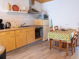 a kitchen with a table and a stove top oven at Bungalow Neues Atelier in Lubmin