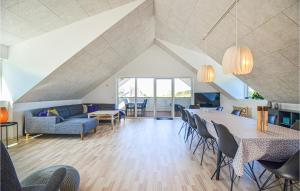 a living room with a long table and chairs at Gorgeous Home In Ebeltoft With Kitchen in Ebeltoft