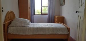 a small bedroom with a bed with a window at Chez Albert et Karine in Sauve