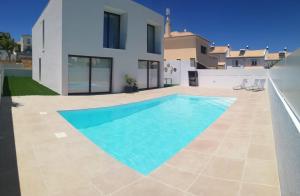 a swimming pool in the backyard of a villa at Villa Algarve in Alcantarilha