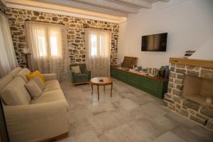 a living room with a couch and a fireplace at Aeonian Villa Ermioni in Ermioni