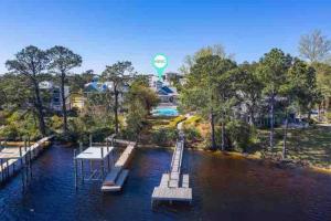 a dock in the water with a hot air balloon at 30A Coastal Home Walk to Beach, Lake & Pool in Inlet Beach
