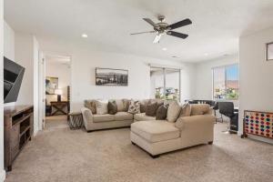 a living room with a couch and a ceiling fan at Desert Solitaire #101 in Santa Clara