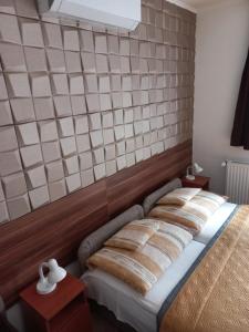 A bed or beds in a room at Boglárka Vendégház