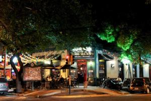 um grupo de pessoas sentadas fora de um restaurante à noite em Loft de lujo en el corazón de Mendoza con Parking em Mendoza