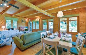 a dining room and living room with a table and chairs at Amazing Home In Varazdinske Toplice With Outdoor Swimming Pool in Varaždinske Toplice