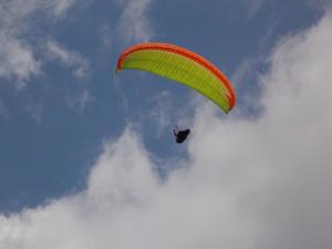 a person riding a parachute in the sky at Apartment and Room Natasa in Kobarid