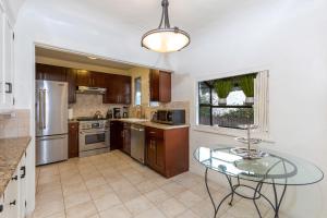 a large kitchen with a glass table in it at Renovated Spanish 3BD 2BA near Beverly Hills in Los Angeles