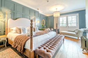 a bedroom with a large bed with a bench in it at Carlton Manor in Hull