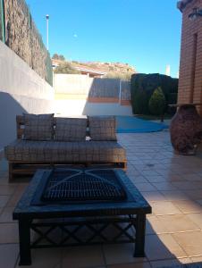 a patio with two couches and a table on a patio at Quevoy in Alcañiz