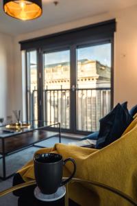a coffee cup sitting on a table in a living room at City View - A Stunning 2 Bed Apartment in Glasgow