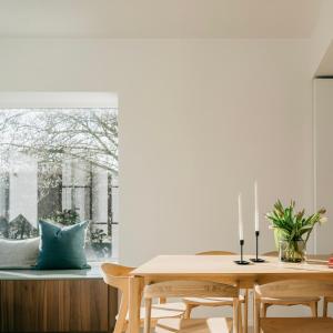 a dining room with a table and a window at MAM Haspengouw in Sint-Truiden