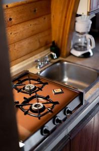 a stove top oven next to a kitchen sink at Backeddy Resort and Marina in Egmont