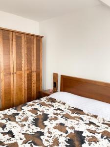 um quarto com uma cama grande e um armário de madeira em Apartments & Rooms Brijest em Plav