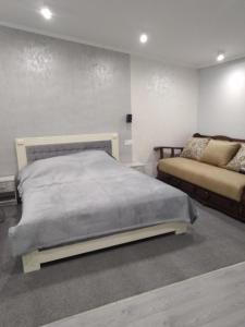 a bedroom with a bed and a couch at На березі річки in Synevyr +53 photos