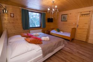 a bedroom with a bed in a wooden room at Gościniec Tokarzonka in Istebna