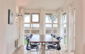 a dining room with a table and chairs in front of a window at It Soal Waterpark-waterlelie in Workum