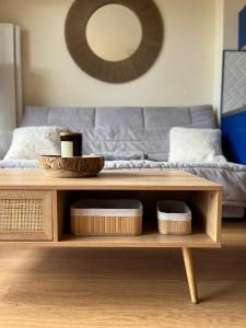 a coffee table in a living room with a couch at * Le Hameau de la plage * in Étables-sur-Mer